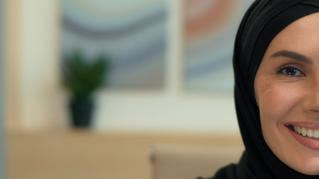 Close up half face portrait muslim islamic woman hijab happy businesswoman smiling toothy smile laugh cheerful girl ethnic Arabian female business employer arabic lady islam beauty health copy spaceの写真素材