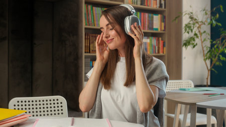 Happy Caucasian woman headphones earphones listening music female girl businesswoman university...