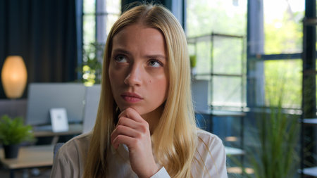 Caucasian young 20s girl smart lady student woman hold hand on chin thinking idea creative brainstorm business female businesswoman employee manager think in office difficult question search answerの写真素材