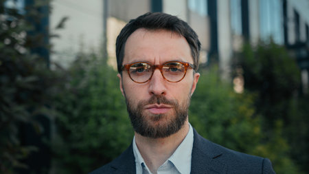 Professional businessman Caucasian man city portrait successful business entrepreneur employer investor wear glasses put on eyeglasses bad vision outdoors smiling at camera outside near modern officeの写真素材