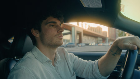 Serious Caucasian man driving sitting inside luxurious car male driver owner businessman hold...