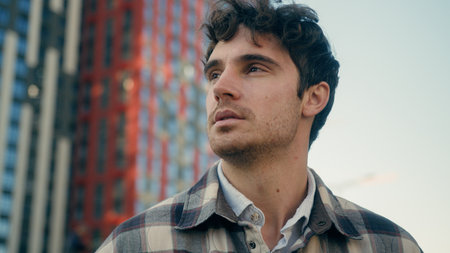 Pensive dreaming thinking Caucasian 30s man tourist guy looking away think ponder in city thoughtful male businessman developer architect real estate agent contemplate look on urban buildings outdoorsの写真素材