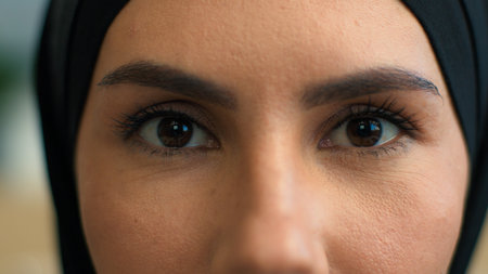 Close up macro extreme eyes woman Muslim islamic female in hijab arabic girl eye opening stare...