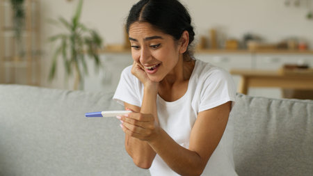 Shocked amazed happy excited smiling Arabian woman pregnant Indian girl future mother female holding...
