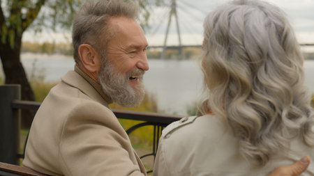 Happy family senior retired Caucasian 60s man laugh smile talk with woman romantic date weekend in...