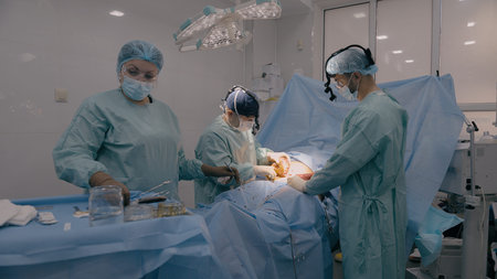 Medical team men doctors physicians surgeons nurse processing surgical operation in hospital clinic...