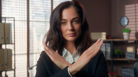 Serious Caucasian woman showing gesture hands crossed refusal stop female girl businesswoman shaking head negative business office forbid deny no never not sign crossing arms indoors reject managerの写真素材