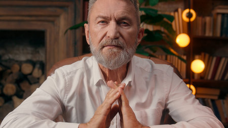 Confident Caucasian old man mature businessman home office takes off glasses business leader boss director looking at camera desk successful European male workplace worker indoors aged pose fingersの写真素材