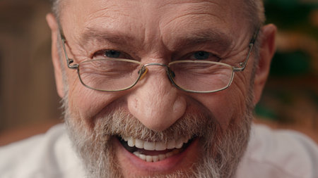 Close up face happy Caucasian European old man elderly wrinkled male expression emotional laugh smile grandfather pensioner businessman investor looking at camera leader retired joy glasses indoorsの写真素材