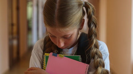 Portrait sad teen girl student pupil learner schoolgirl upset lonely child kid school college academy hall looking at camera frustrated alone worried fail exam studying learning problem bad educationの写真素材