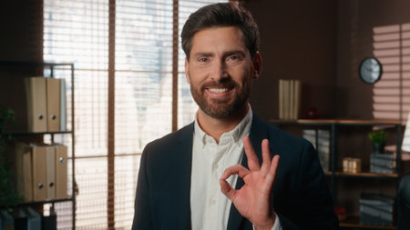Happy smiling man male mature businessman business employer showing okay gesture ok sign happy carefree smiling satisfied good work result fine job growth specialist professional in office posingの写真素材