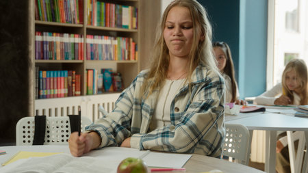 Stressed angry Caucasian teen sad girl school student pupil kid child schoolgirl study exam task...