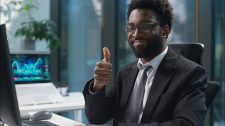 African American man typing computer working online job work businessman male looking at camera...