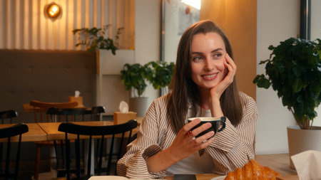 Young happy smiling inspiration business woman girl female businesswoman dreaming thinking working in cafe writing notes in notebook drinking coffee morning diary information write creative processの写真素材