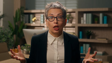 Business problem angry talking negative speaking mad furious arguing talk to camera video call Caucasian senior woman middle-aged businesswoman mature female worker entrepreneur in office work failureの写真素材