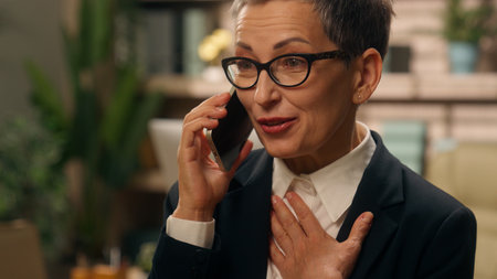 Portrait in office happy emotional talking amazed wonder surprised shocked gray haired elderly mature senior old businesswoman business woman female talking mobile phone communicate smartphone callの写真素材