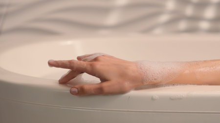 Moving shot female hand with foam woman enjoying calm leisure beauty hygiene self care soapy foamy...