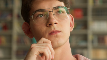 Close up hesitate Caucasian teenager guy pensive holding chin thinking decision solution difficult...