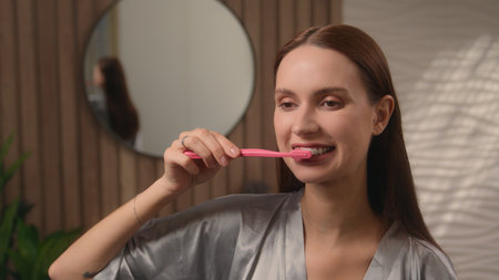 Portrait at home bathroom woman attractive female lady girl beauty routine bath morning procedure health medicine toothy care brushing whitening teeth oral hygiene toothbrush toothpaste healthy habitの写真素材
