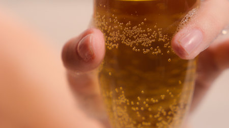Close up cropped view relaxing Caucasian relaxed woman female girl lady in spa bathing washing foam at home holding glass of champagne alcohol drinking beverage drinkの写真素材