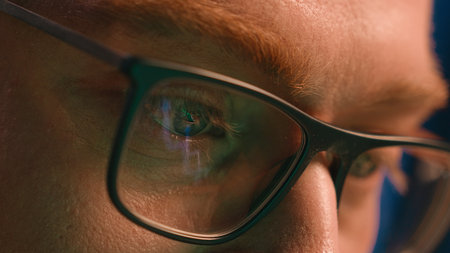 Close up cropped view details male eyes in eyeglasses eyewear glasses Caucasian man business guy businessman night gamer programmer looking laptop computer screen online reflection eye health visionの写真素材