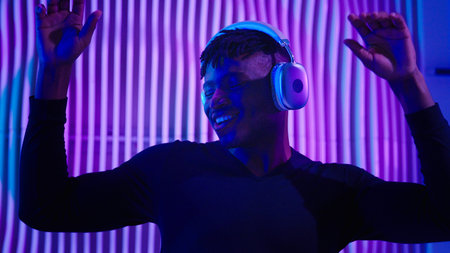 African American man guy male dancing DJ mix listening audio song sound music in modern wireless...