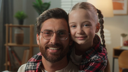 Together love daddy with daughter smiling hugging by neck embrace relationship enjoying spending time at home cute moment happy kid girl daughter hug beloved father parent man domestic portrait familyの写真素材