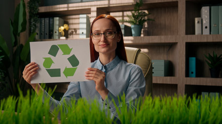 Caucasian woman girl businesswoman green business recycling eco zero waste project sorted paper bio clean energy take care environment recycle symbol reusing in office reduce garbage global ecologyの写真素材