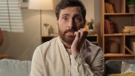 Caucasian man homeowner guy at home shrug shoulders unsure confused male stress uncertain homeowner businessman looking at camera thoughtful unknown problem question doubt in apartment stressful lostの写真素材