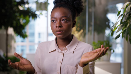 African American ethnic business woman girl thinking pensive businesswoman doubt puzzled female employer student manager in office problem solution think idea question planning deep thought confusionの写真素材