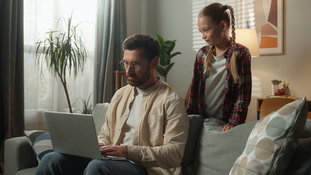 Caucasian family problem busy father man working laptop daughter noisy bad behavior distracted distant work at home little child kid girl naughty energetic fatherhood trouble stress dad angry talkingの写真素材