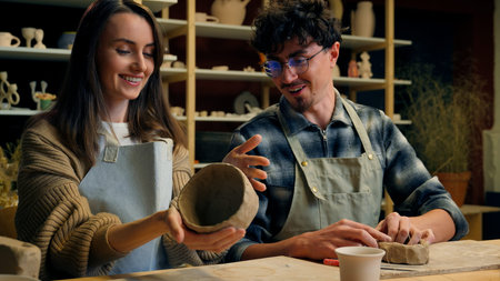 Caucasian family smiling girl guy couple date in pottery workshop handmade master class woman potter...