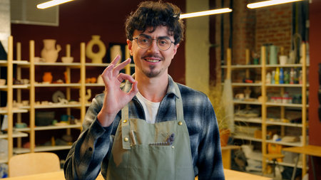 Caucasian man portrait smiling guy sculptor potter craftsman in pottery workshop designer artisan...