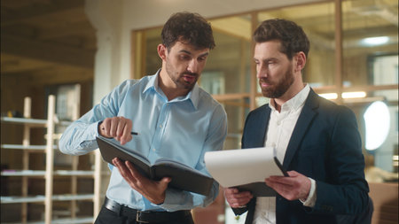 Caucasian men business colleagues businessmen argue discussing documents corporate paperwork bank...