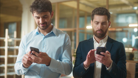 Busy men colleagues businessmen business partners Caucasian guys co-workers managers entrepreneurs usage mobile phones gadgets addict male employees messaging online technology smartphones in officeの写真素材