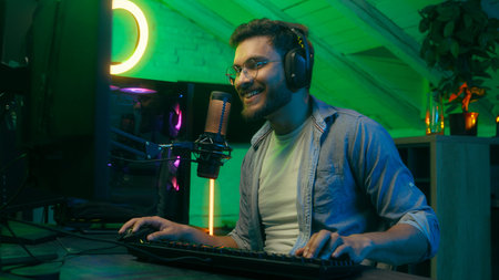 Emotional smiling talking in microphone video game addict Caucasian guy male man streamer gamer...