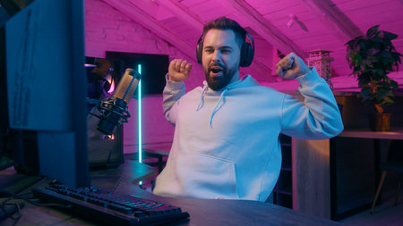 Tired exhausted sleepy Caucasian addicted male gamer guy man streamer play at computer yawning low energy internet virtual gaming at home web battle online video game at night late time addictionの写真素材