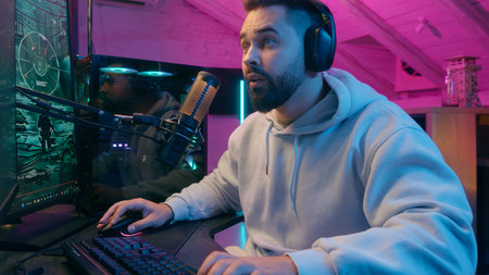 Caucasian man guy male gamer streamer playing online game shocked worried anxiety astonish shock at night lost upset frustrated failure addiction streaming in neon room player computer gaming problemの写真素材