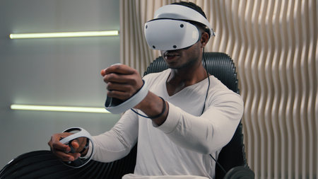 Futurism gaming internet video game virtual reality African American man male guy in vr glasses helmet playing 3d world in white futuristic room indoors modern online having fun enjoy play metaverseの写真素材