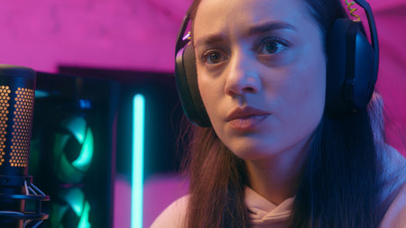 Angry mad aggressive emotional yelling Caucasian woman female girl user gamer streamer talking microphone talk to mic typing keyword stream computer lost failure playing online video game streamingの写真素材