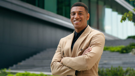Portrait confident crossed hands folded arms smile happy African American male entrepreneur looking at camera employer guy business man realtor real estate in city urban businessman office buildingの写真素材