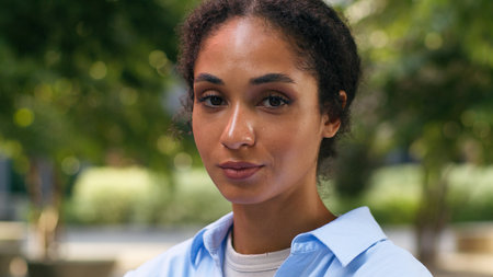 Portrait calm positive face ethnic African American student girl female business woman businesswoman lady entrepreneur manager in city urban outdoors work study education internship looking at cameraの写真素材