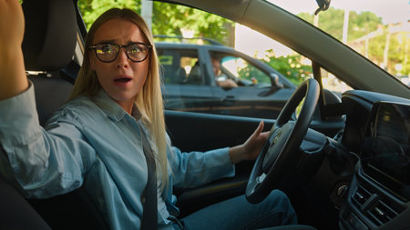 Caucasian woman driver car automobile auto transport vehicle quarrel conflict road traffic jam shouting scream arguing female angry girl businesswoman business city misunderstanding honk talk accidentの写真素材