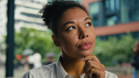 Thoughtful African American thinking contemplate pondering decision choosing work entrepreneur woman female girl businesswoman business solve puzzled solution manager consider planning city outdoorsの写真素材