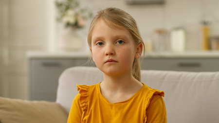 Close up European little girl looking at camera child daughter kid childhood face offspringの写真素材