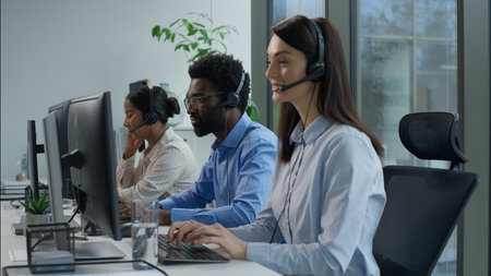Call center support multiethnic business men women workers agents headphones headset telemarketing virtual assistant operators working computer typing customer client helpline distance office onlineの写真素材