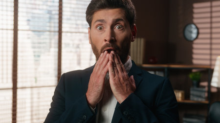 Caucasian middle-aged business man adult businessman guy male employer entrepreneur in office amazed shock wonder stunned big eyes open mouth close with hand shock news amazing offer looking at cameraの写真素材
