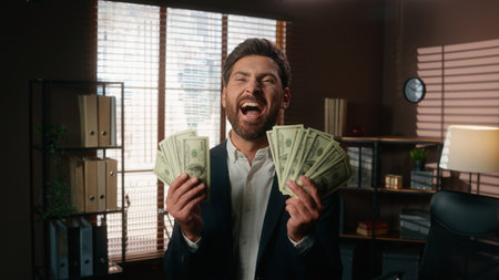 Emotional happy rich successful excited Caucasian businessman in office business man male guy manager worker employer yell showing money banknotes dollars triumph financial win victory yelling wealthの写真素材