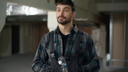 Builder engineer wearing gloves safety construction Caucasian man architect foreman master in...
