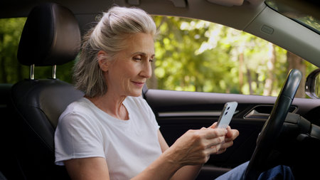 Relaxed calm Caucasian woman retired elderly female mature senior automobile driver pensioner inside...